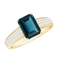 Rosec Jewels engagement ring featuring a 6x8mm London Blue Topaz side stone with diamond accents, elegant jewelry design.