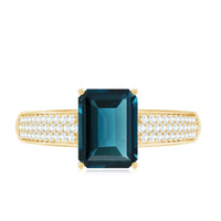 Rosec Jewels 6x8mm London Blue Topaz side stone engagement ring with diamonds, showcasing a stunning emerald cut gemstone and elegant design.