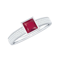 Natural 0.8 carat ruby princess cut engagement ring with diamond accents on a rose gold band, from Rosec Jewels.