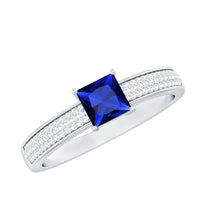 Rosec Jewels 5mm princess cut lab-created blue sapphire promise ring with diamond accents, showcasing the elegant gemstone setting.