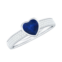 Blue sapphire heart solitaire engagement ring with pave diamonds by Rosec Jewels, featuring a stunning blue gemstone and sparkling accents.