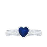 Blue sapphire heart solitaire engagement ring with pave diamonds from Rosec Jewels, showcasing a sparkling blue sapphire centerpiece.