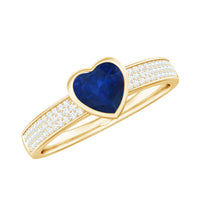 Blue sapphire heart solitaire engagement ring with pave diamonds by Rosec Jewels, featuring a central blue sapphire and diamond accents.
