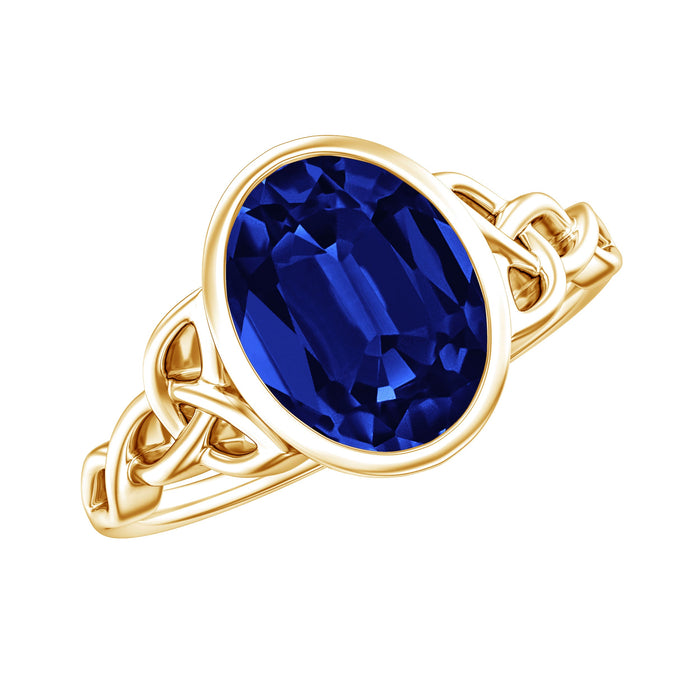 Oval lab-grown blue sapphire engagement ring with bezel setting by Rosec Jewels, featuring a 4-carat gemstone and silver band.