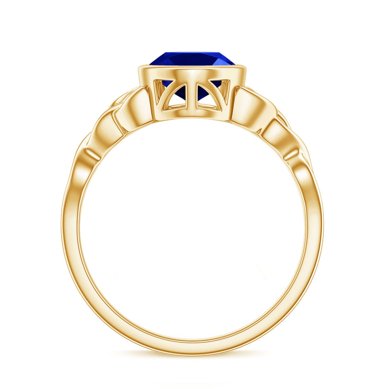 Oval lab-grown blue sapphire engagement ring with bezel setting, crafted by Rosec Jewels, featuring a 4-carat center stone.