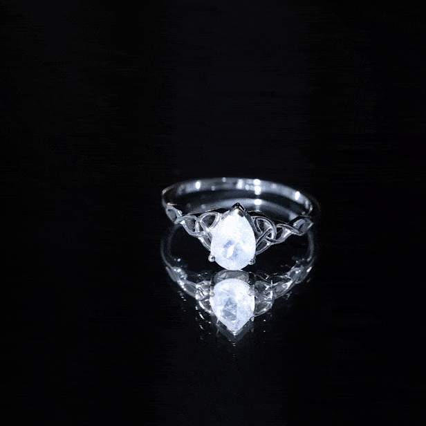 Pear-shaped moonstone solitaire engagement ring with Celtic band from Rosec Jewels, featuring a shimmering moonstone gemstone.
