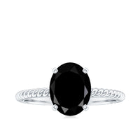 Oval cut black onyx solitaire engagement ring with diamond accents, featuring a sleek design and silver band by Rosec Jewels.
