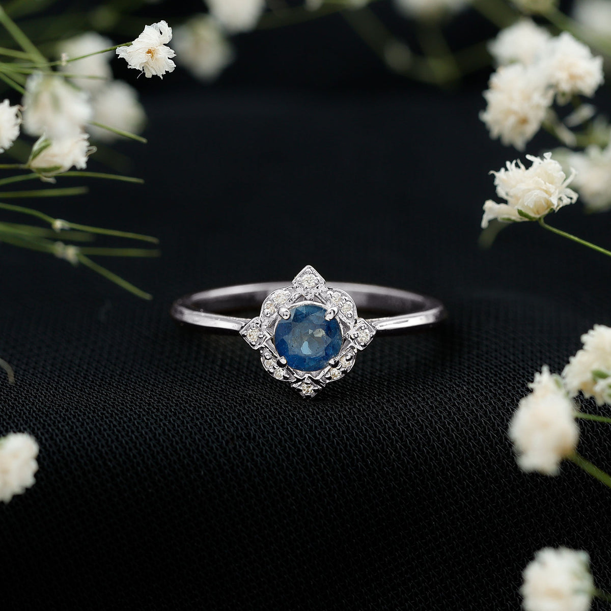 Vintage-style 0.9 carat blue sapphire engagement ring with diamond halo by Rosec Jewels, featuring intricate metalwork and sparkling stones.