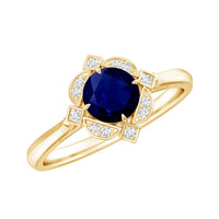 Vintage style 0.9 carat blue sapphire engagement ring with diamond halo, featuring intricate gold band and sparkling gemstone details