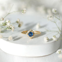 Vintage style 0.9 carat blue sapphire engagement ring with diamond halo, featuring intricate band details, by Rosec Jewels.
