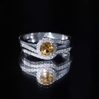 Genuine citrine engagement ring with diamond wedding band, showcasing yellow citrine and sparkling diamonds on a silver setting.