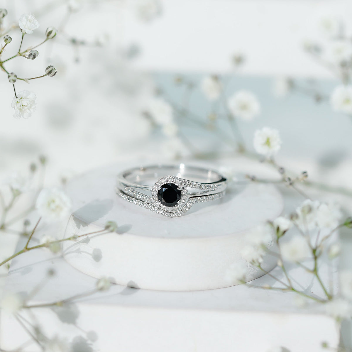Black Onyx wedding rings set by Rosec Jewels featuring a minimal band with a diamond-curved accent on a sleek ring design.