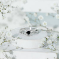 Black Onyx wedding rings set by Rosec Jewels featuring a minimal band with a diamond-curved accent on a sleek ring design.