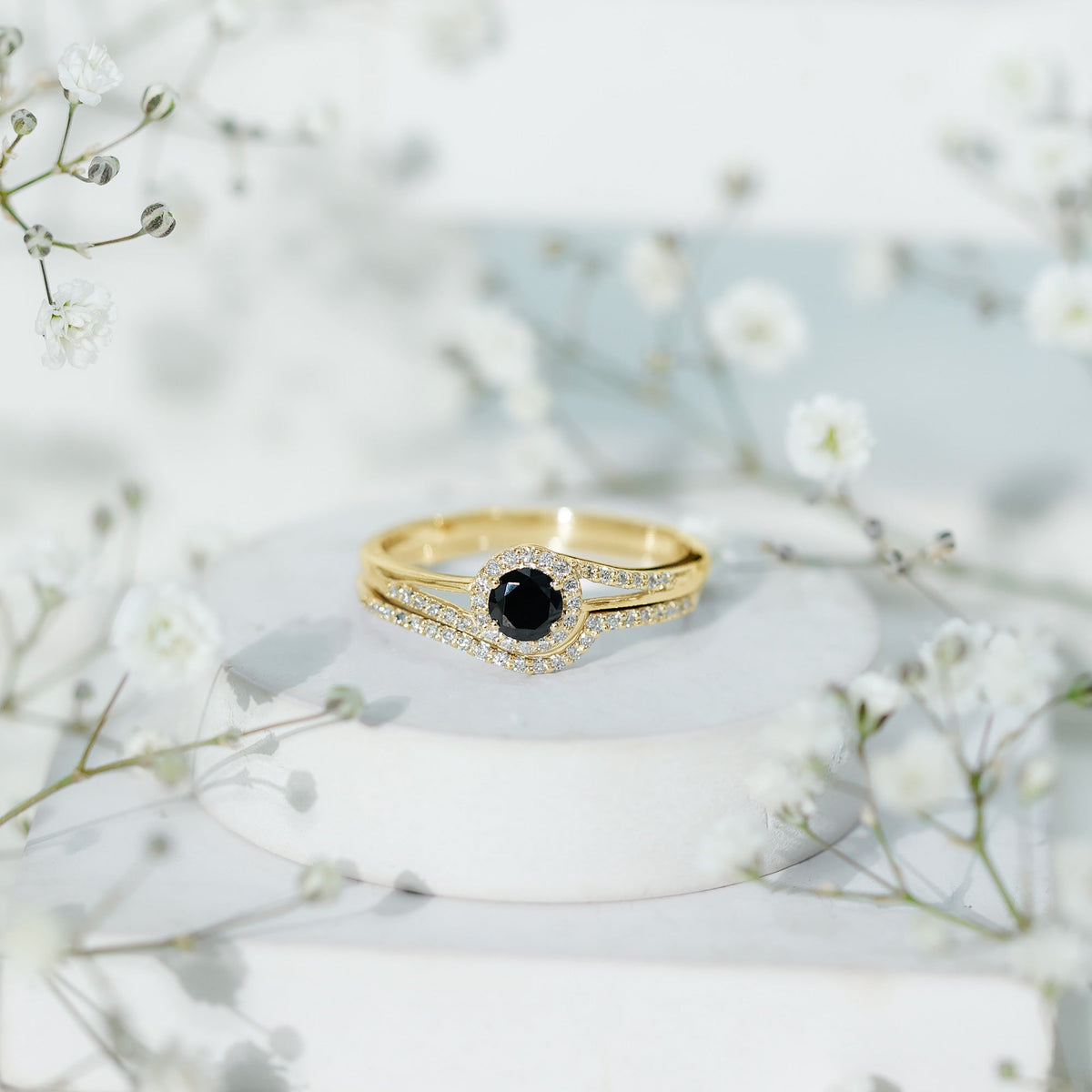 Black Onyx and diamond curved wedding rings set by Rosec Jewels, featuring minimalist design and polished band details.