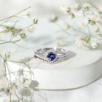 Genuine Tanzanite engagement ring with diamond enhancer featuring a deep blue tanzanite gemstone and sparkling diamond accents.