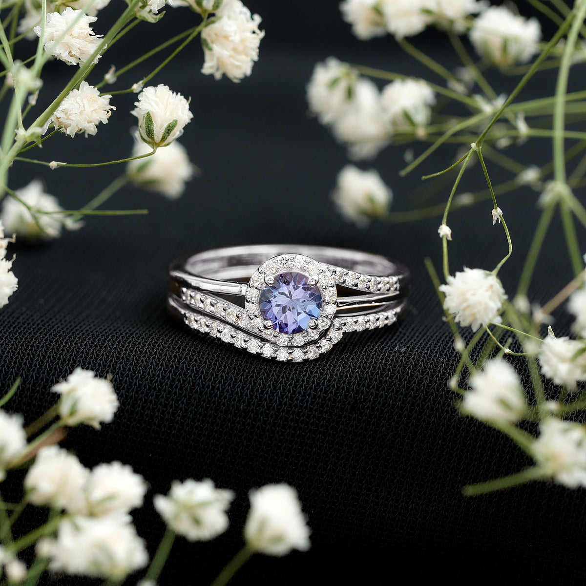 Genuine Tanzanite engagement ring with diamond enhancer, featuring a stunning violet-blue tanzanite gemstone set in a elegant ring design.