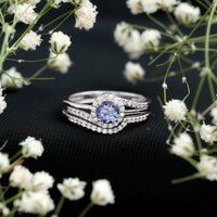 Genuine Tanzanite engagement ring with diamond enhancer, featuring a stunning violet-blue tanzanite gemstone set in a elegant ring design.