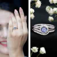 Genuine Tanzanite engagement ring with diamond enhancer featuring a deep blue tanzanite gem and sparkling diamonds in a rose gold setting.