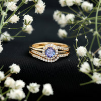 Genuine Tanzanite engagement ring with diamond enhancer, featuring a vibrant blue Tanzanite gemstone set in a rose gold ring.