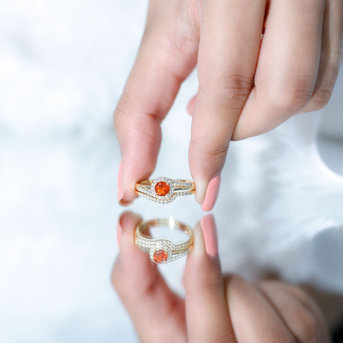Certified fire opal engagement ring with diamond enhancer featuring a vibrant orange fire opal and sparkling diamonds in a rose gold setting
