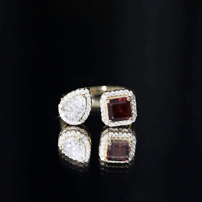 Natural garnet and moissanite toi et moi engagement ring in yellow gold plated silver, showcasing elegant gemstone settings.
