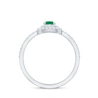 Round emerald and diamond double halo engagement ring by Rosec Jewels, showcasing intricate diamond-encrusted halo design.