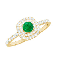 Round emerald and diamond double halo engagement ring showcasing a central emerald surrounded by sparkling diamonds on a silver band.