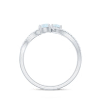 Minimal moonstone and diamond engagement ring from Rosec Jewels, showcasing a delicate band with a central moonstone and small diamonds.