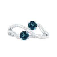 Rosec Jewels London Blue Topaz 2-stone promise ring with diamonds, showcasing the elegant blue gemstone and sparkling accents.