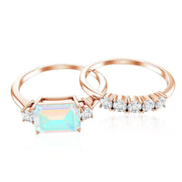 Ethiopian opal diamond engagement and wedding ring set with emerald cut stones in rose gold, featuring intricate band details.