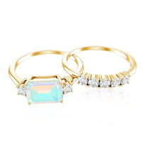 Ethiopian opal, diamond, and emerald cut engagement ring and wedding band set by Rosec Jewels featuring natural gemstones and elegant design.