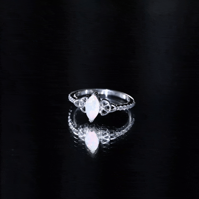 Natural Ethiopian opal diamond engagement ring with Celtic knot design, featuring yellow gold band and sparkling gemstones.