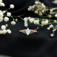 Natural Ethiopian opal diamond engagement ring with Celtic knot design, featuring sparkling gemstones and intricate metalwork.