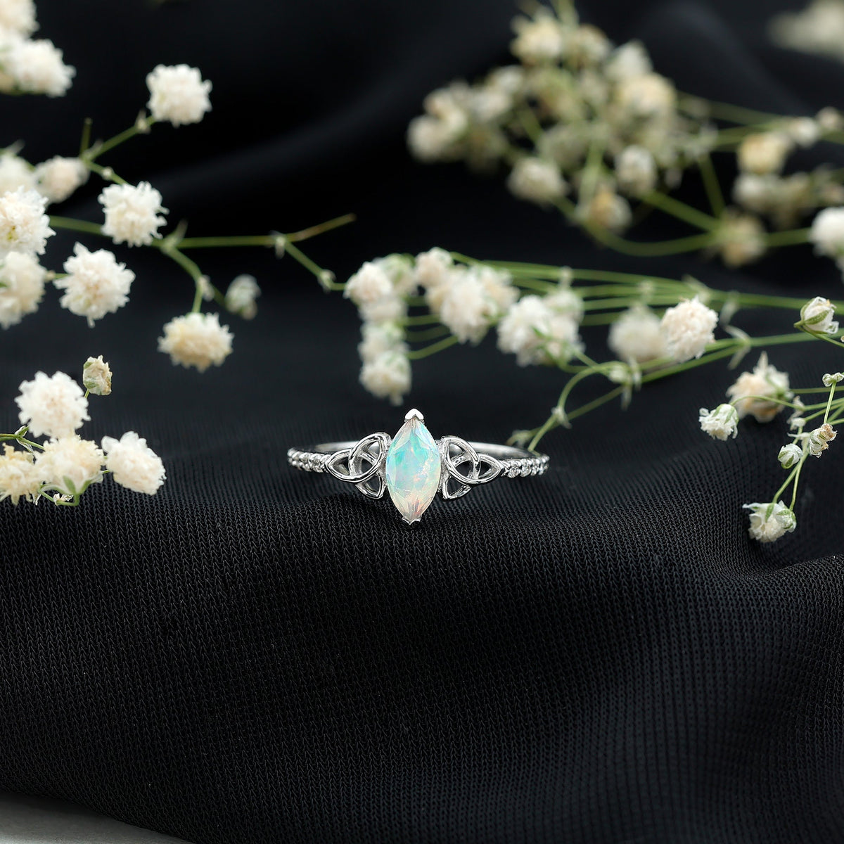 Natural Ethiopian opal diamond engagement ring with Celtic knot design, featuring sparkling gemstones in a Rosec Jewels ring.