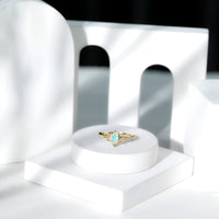 Natural Ethiopian opal diamond engagement ring with Celtic knot design, featuring a Rosec Jewels ring in elegant gold setting.