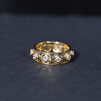 Lab created pink sapphire wedding band with Celtic details, Rosec Jewels rings featuring intricate metalwork and a pink gemstone centerpiece.