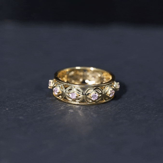 Lab-created pink sapphire wedding band with Celtic details, featuring rose gold finish and intricate design by Rosec Jewels.