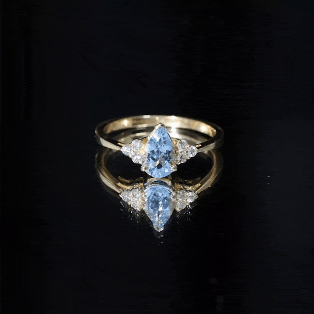 Rosec Jewels 1 Carat aquamarine pear engagement ring with diamond trio, featuring a sparkling aquamarine stone and elegant design.