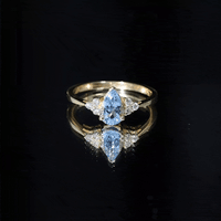 Rosec Jewels 1 Carat aquamarine pear engagement ring with diamond trio, featuring a sparkling aquamarine stone and elegant design.