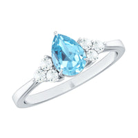 Elegant 1 carat aquamarine pear-shaped engagement ring with diamond trio accents by Rosec Jewels, showcasing fine jewelry craftsmanship.