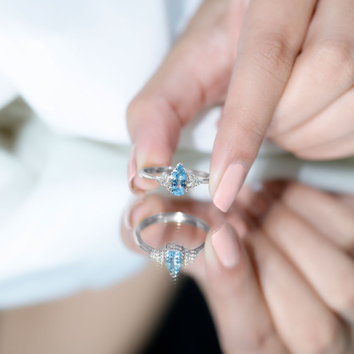 Pear-shaped 1 Carat Aquamarine engagement ring with diamond trio accents by Rosec Jewels, showcasing elegant gemstone and fine setting.