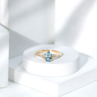 Elegant 1 carat aquamarine pear-shaped engagement ring with diamond trio accents by Rosec Jewels, showcasing a sparkling gemstone setting.