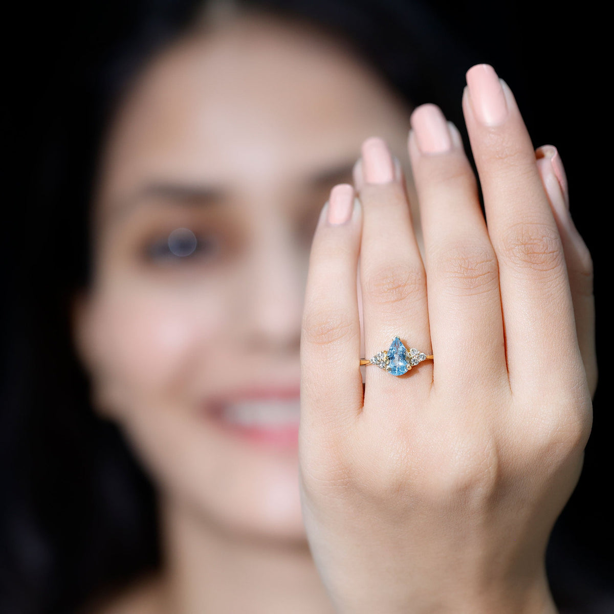 Pear-shaped 1-carat aquamarine engagement ring with diamond trio accents by Rosec Jewels, showcasing a elegant and sparkling design.