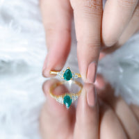 Pear-shaped emerald engagement ring with 0.6 carat AAA quality gemstone and diamond accents, featuring a delicate band from Rosec Jewels.