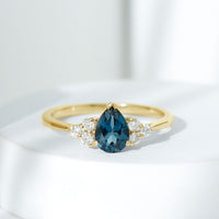 5X7mm Pear Shape London Blue Topaz Engagement Ring with Diamond Trio