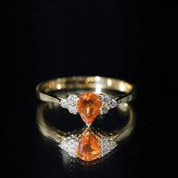 Pear-shaped 0.6 carat fire opal engagement ring with diamond trio accents by Rosec Jewels, showcasing a elegant gemstone setting.