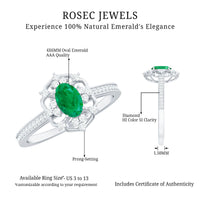 Vintage style emerald and diamond oval engagement ring by Rosec Jewels, featuring a central emerald surrounded by sparkling diamonds.