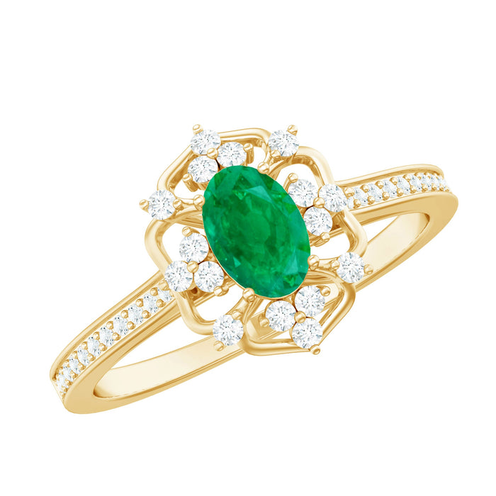 Vintage style emerald and diamond oval engagement ring from Rosec Jewels, featuring intricate metalwork and sparkling gemstones.