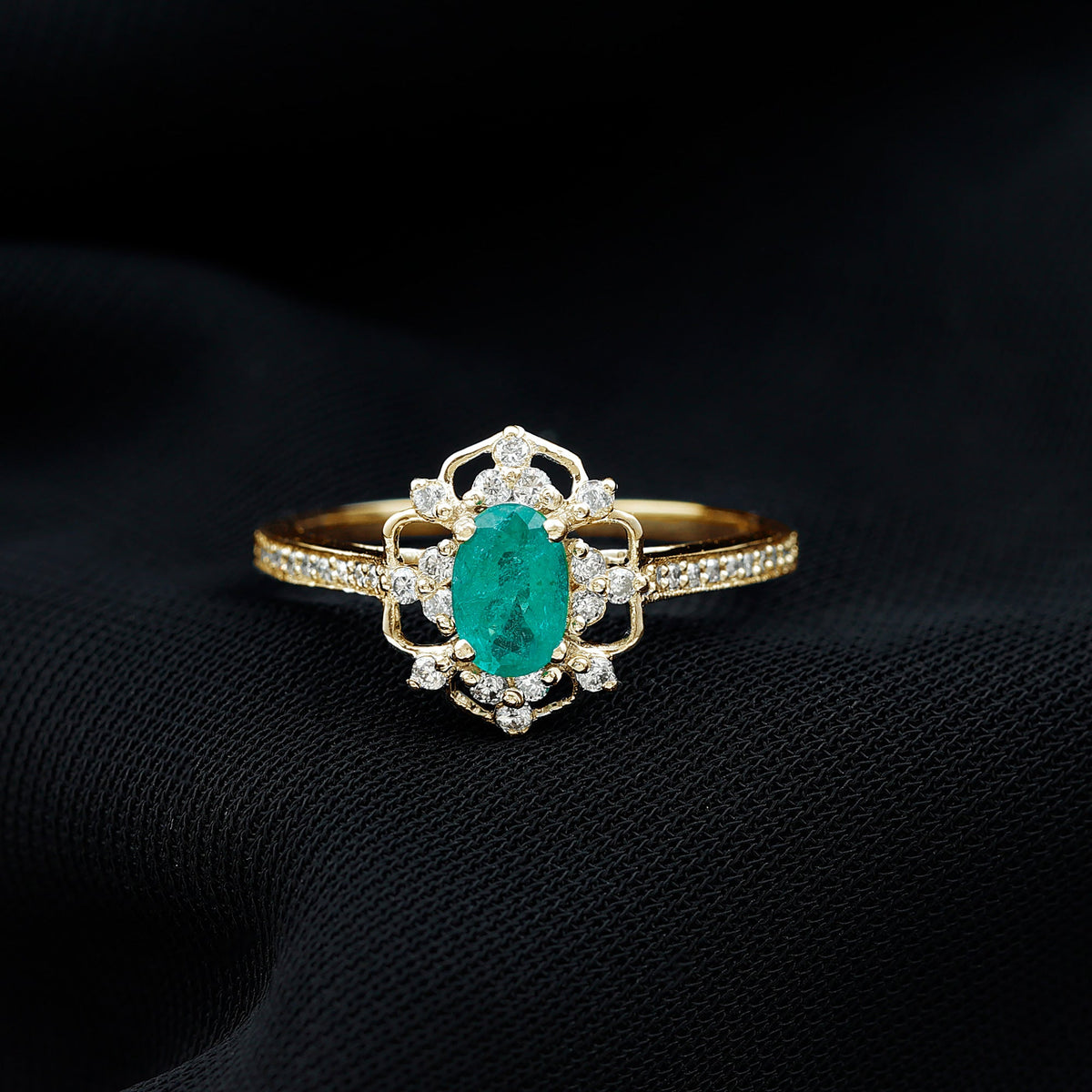 Vintage style emerald and diamond oval engagement ring by Rosec Jewels featuring detailed craftsmanship and elegant design.
