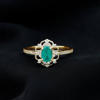 Vintage style emerald and diamond oval engagement ring by Rosec Jewels featuring detailed craftsmanship and elegant design.
